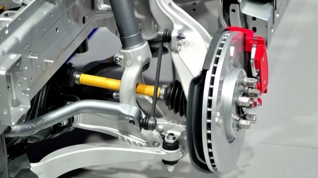 Zdjecie przedstawia elementy zawieszenia i układu hamulcowego.